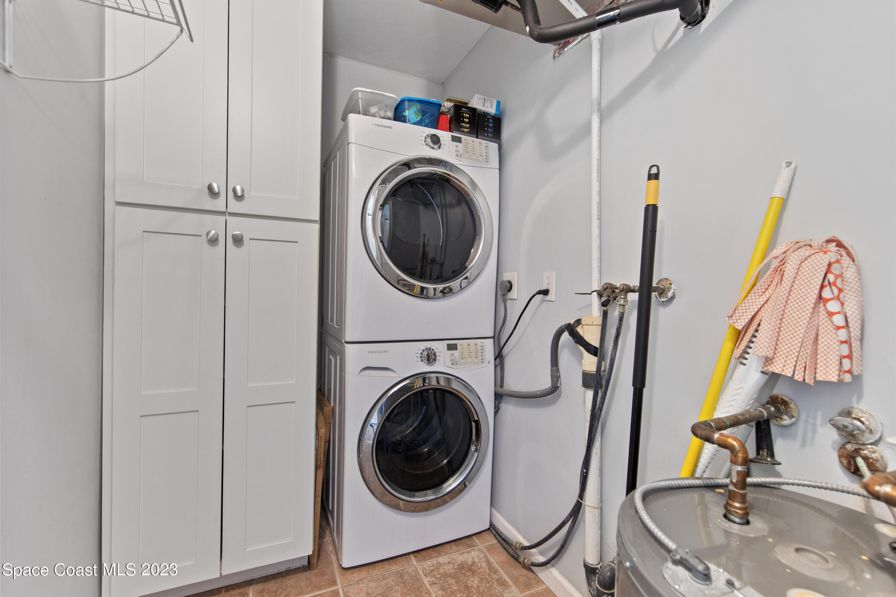 4150 Florida A1A, Unit 104 Vero Beach, FL 32963 - Photo 22 of 30 a view of a storage & utility room with sink washer and dryer