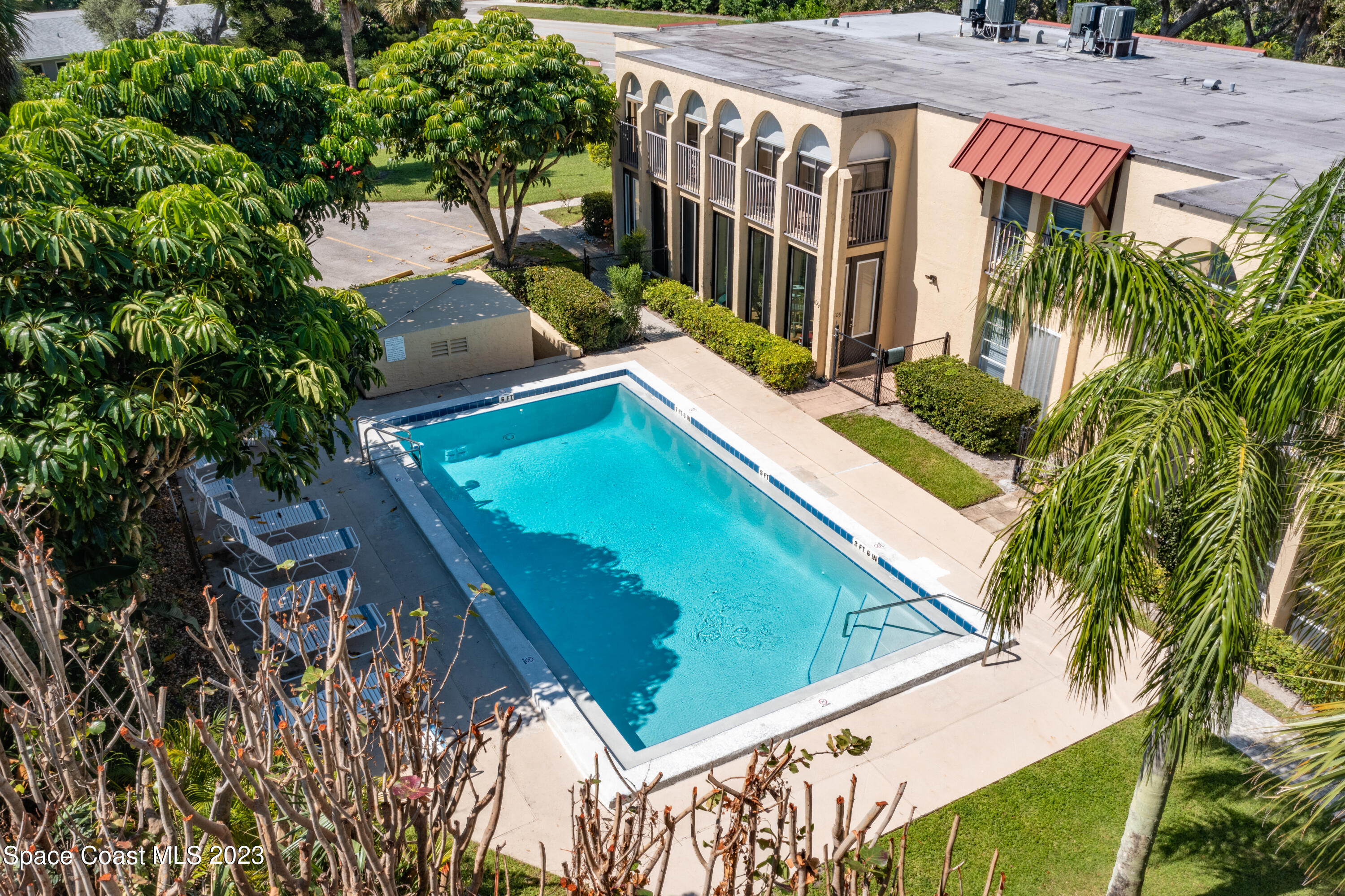 4150 Florida A1A, Unit 104 Vero Beach, FL 32963 - Photo 27 of 30 a view of a yard with plants and wooden fence