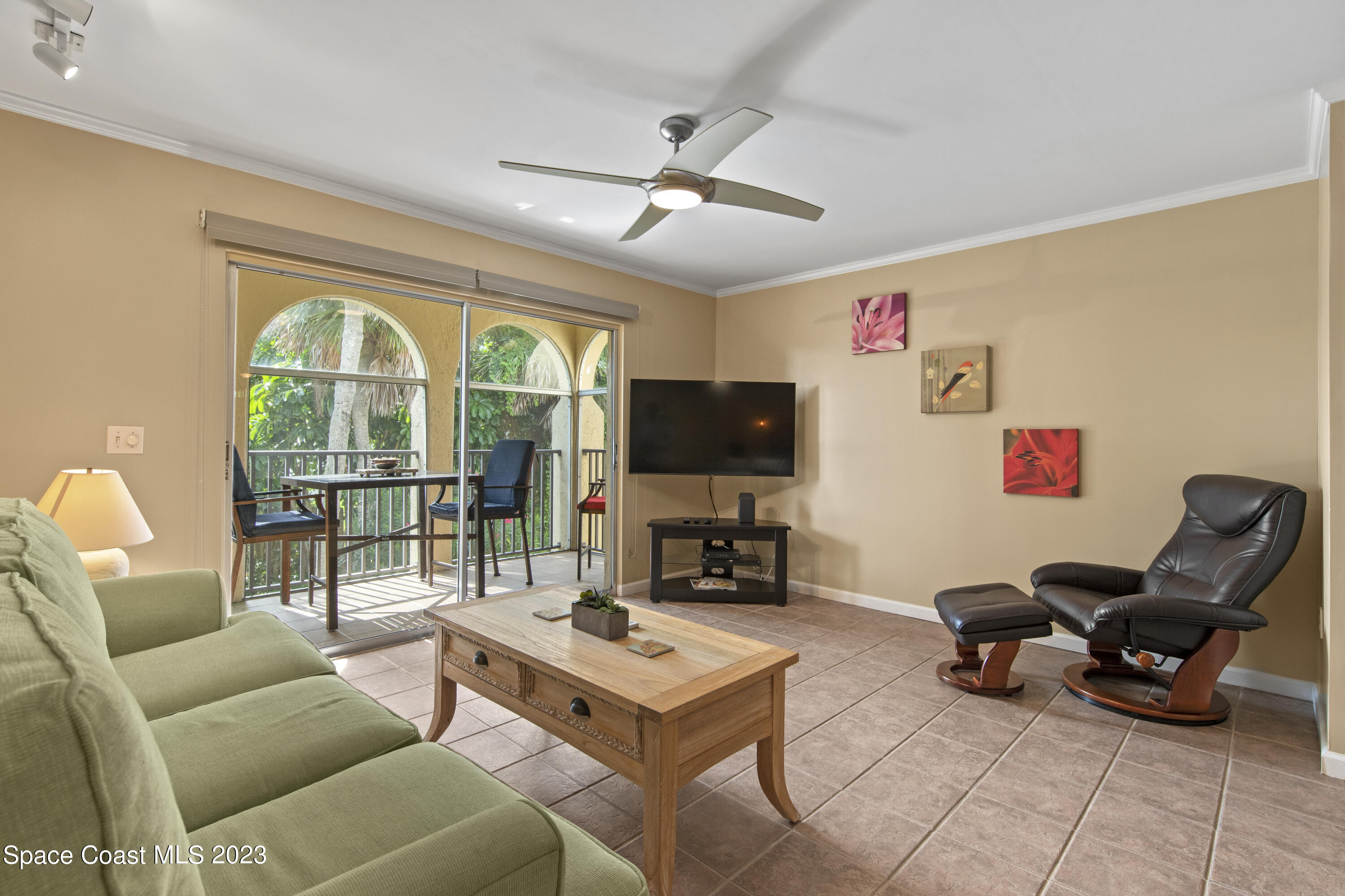 4150 Florida A1A, Unit 104 Vero Beach, FL 32963 - Photo 4 of 30 a living room with furniture a flat screen tv and a large window