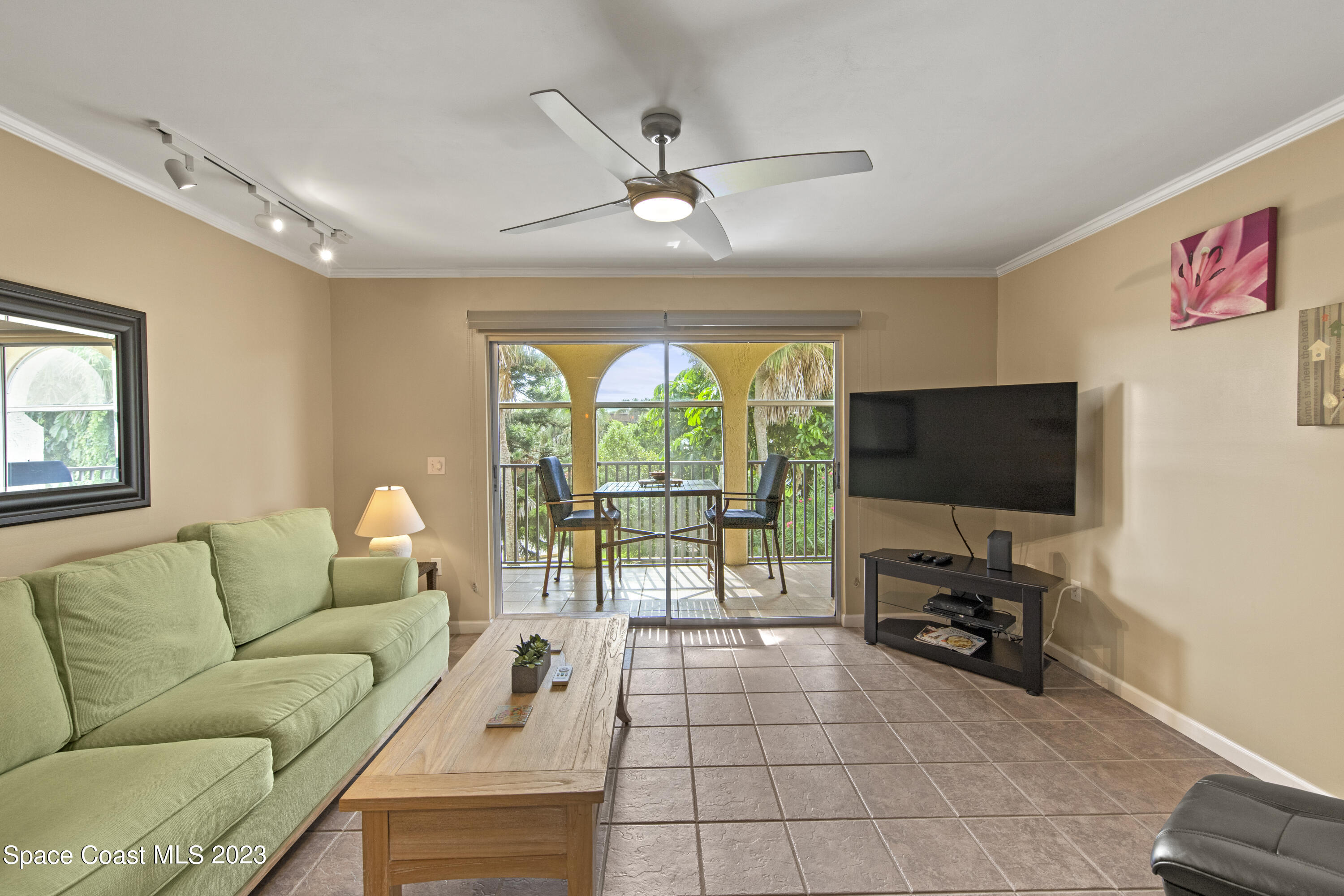 4150 Florida A1A, Unit 104 Vero Beach, FL 32963 - Photo 5 of 30 a living room with furniture and a flat screen tv