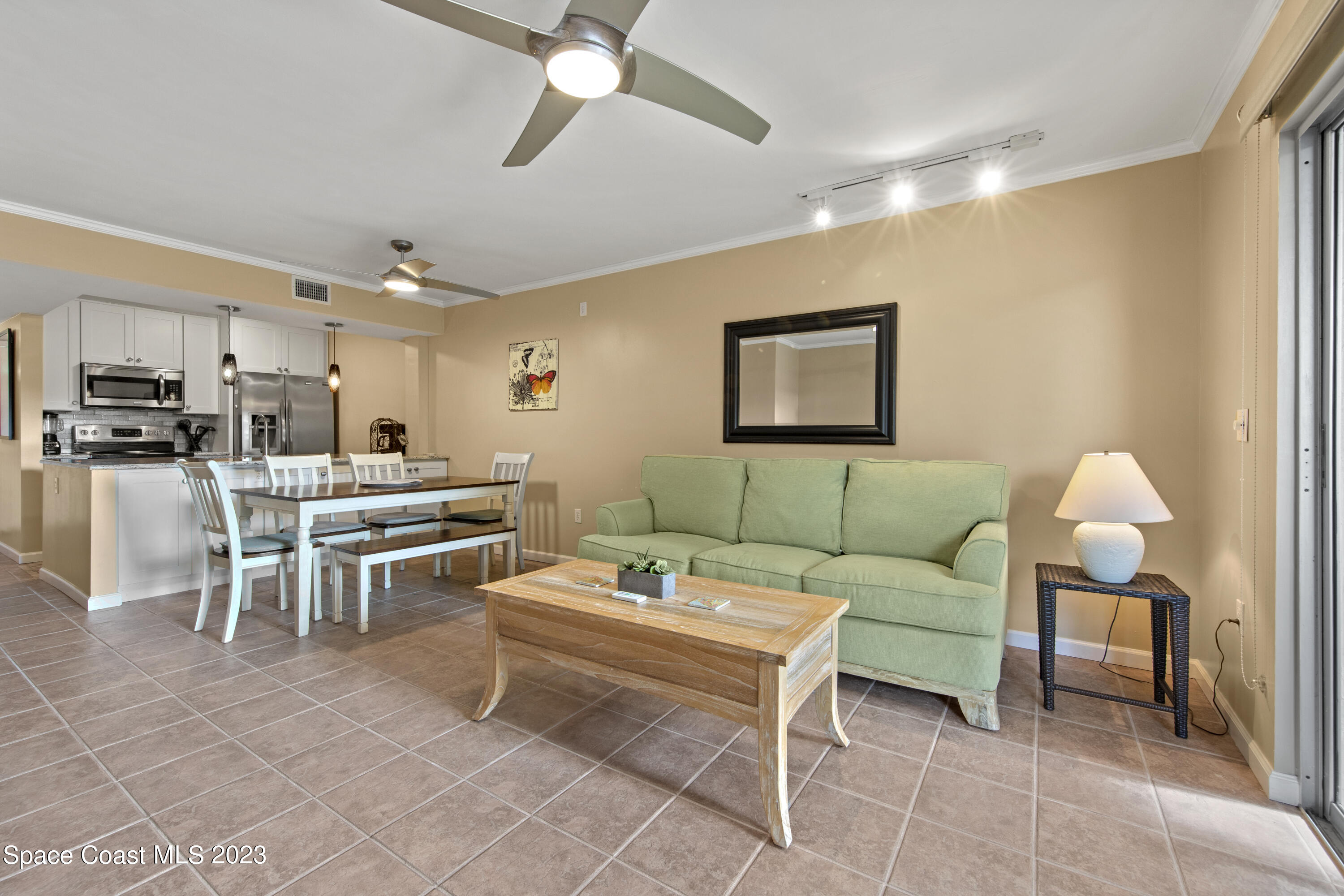 4150 Florida A1A, Unit 104 Vero Beach, FL 32963 - Photo 6 of 30 a living room with lots of furniture and kitchen view