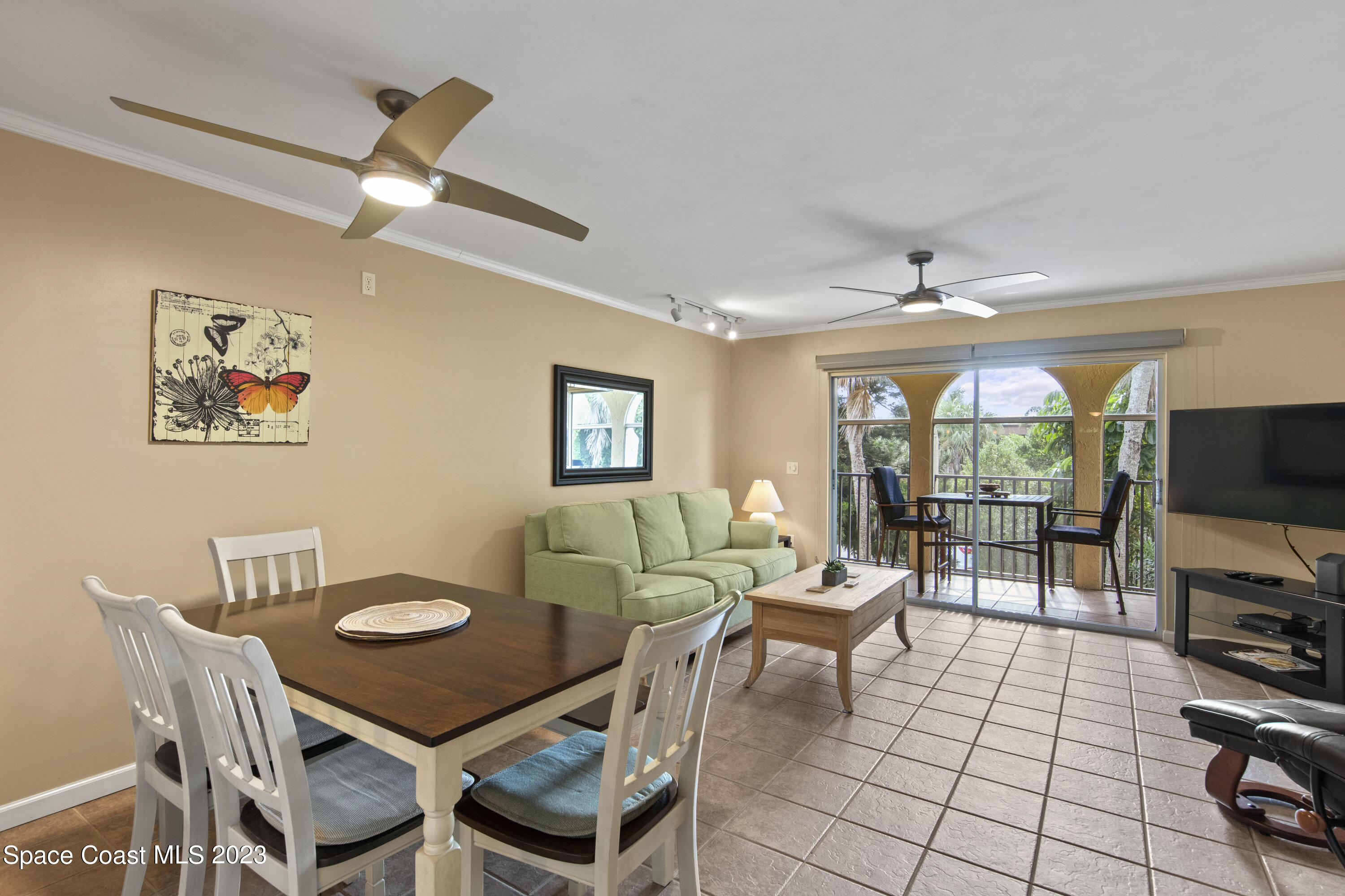 4150 Florida A1A, Unit 104 Vero Beach, FL 32963 - Photo 9 of 30 a living room with furniture a flat screen tv and a window