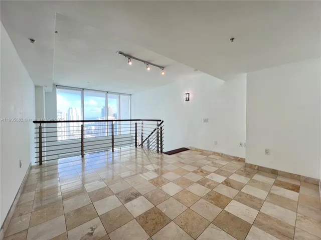 a bathroom with a granite countertop sink a toilet a mirror and shower