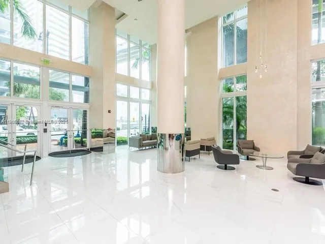 a view of living room with furniture and floor to ceiling window