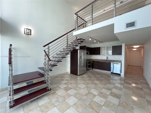 a kitchen with a stove a sink and a refrigerator