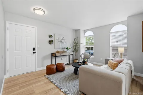 a living room with furniture potted plant and a window