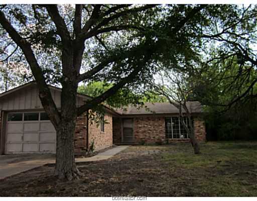 607 Olive Street Bryan, TX 77801 - Photo 1 of 1 a tree in front of a white house