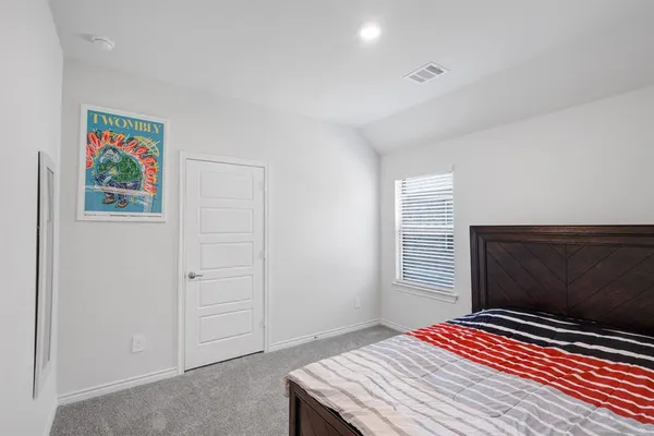 a bedroom with a bed and a window