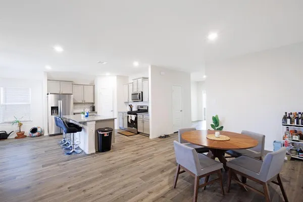 a view of a dining room with furniture and wooden floor