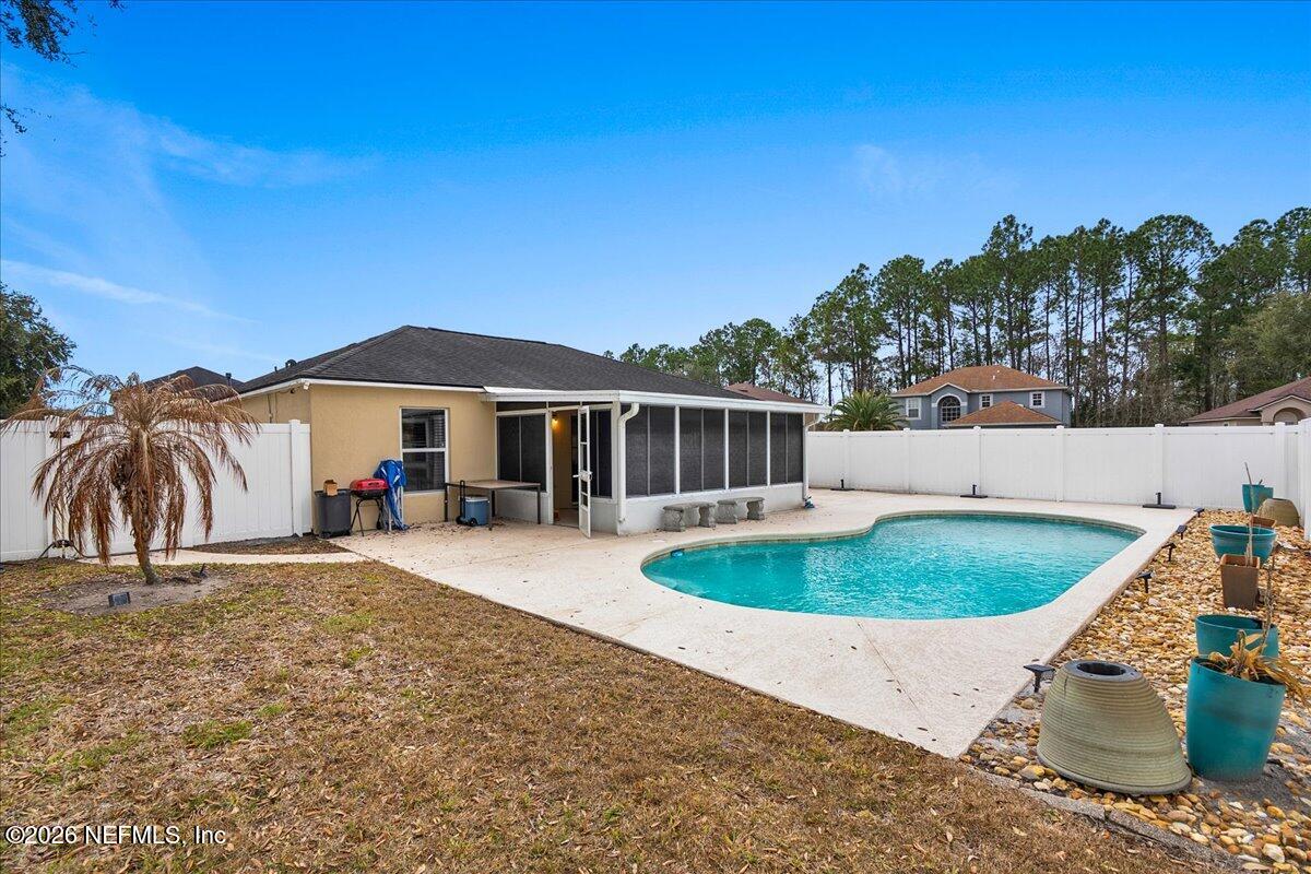 10310 Woodley Point Road Jacksonville, FL 32218 - Photo 25 of 30 an outdoor space with furniture and umbrella