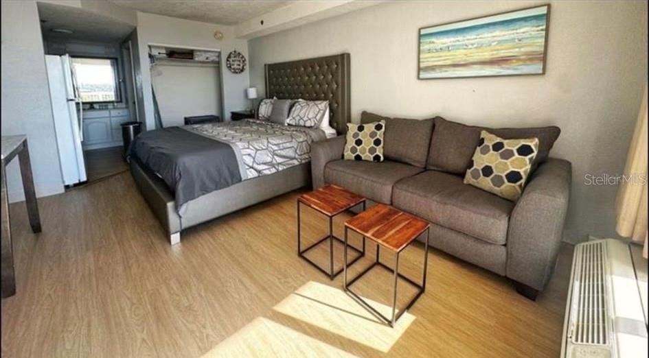 2700 North Atlantic Avenue, Unit 429 Daytona Beach, FL 32118 - Photo 5 of 11 a bedroom with a bed couch and a window
