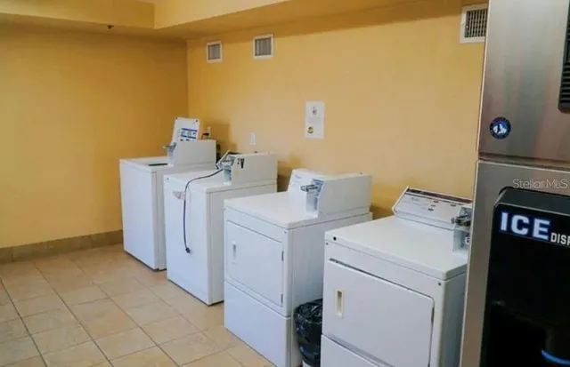 a kitchen with stainless steel appliances granite countertop a refrigerator and a stove