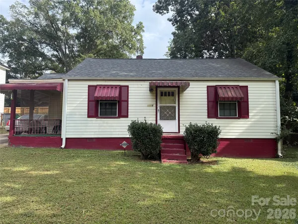 a view of brick house with a yard