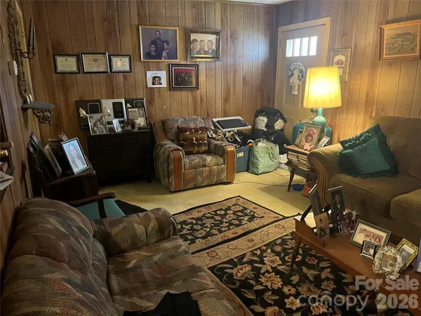 a living room with furniture and a lamp