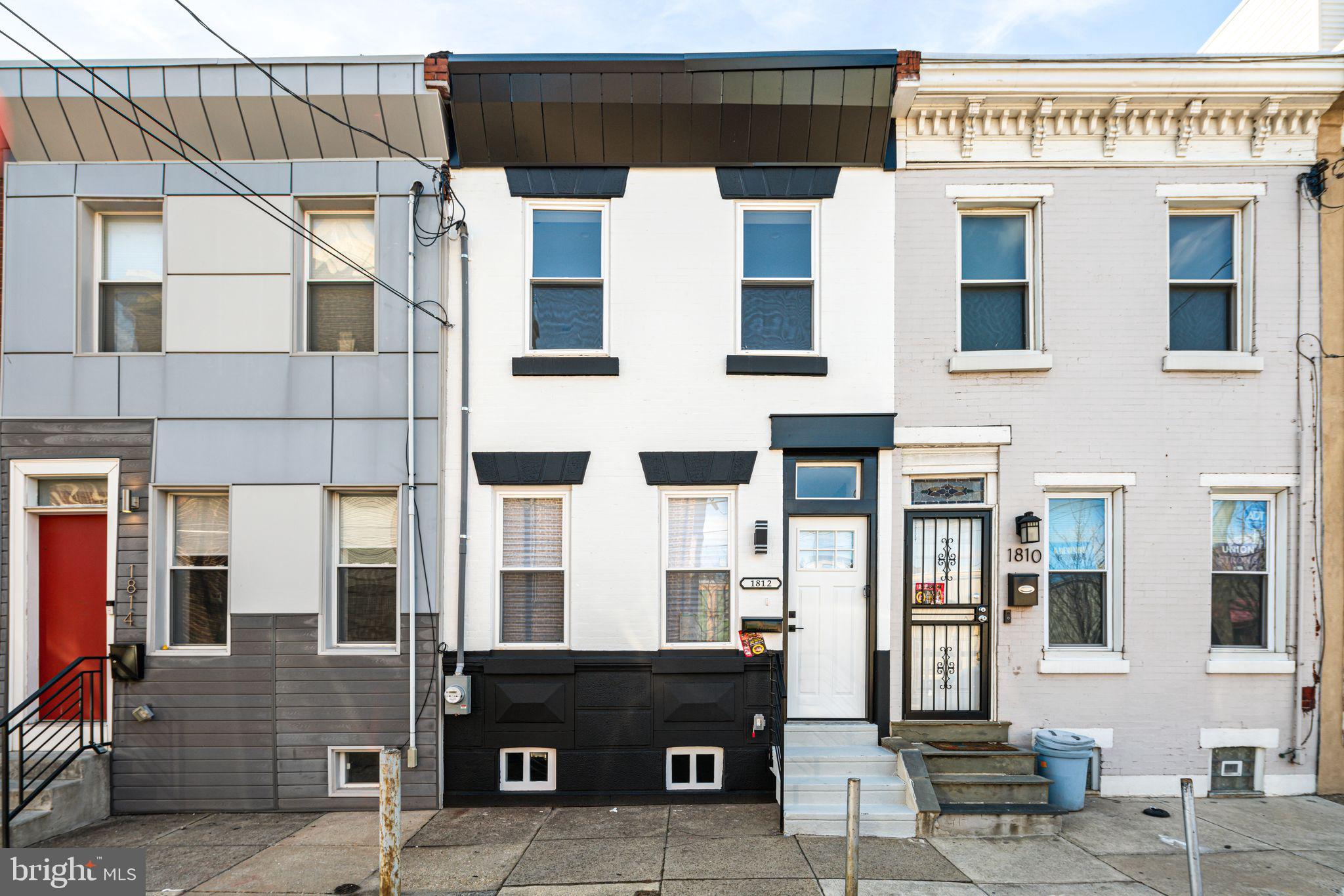 a view of a building with a door and a large window
