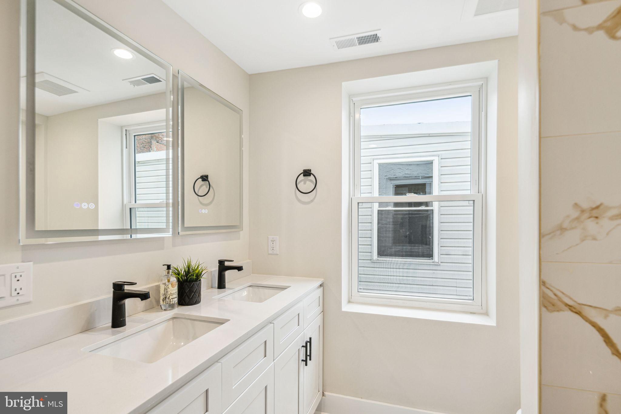 1812 East Letterly Street Philadelphia, PA 19125 - Photo 12 of 26 a bathroom with a granite countertop sink and a mirror