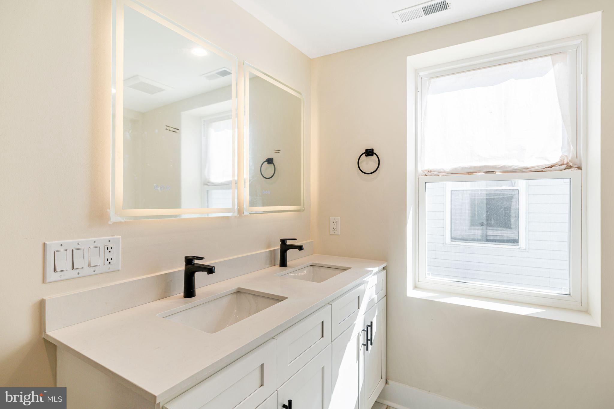1812 East Letterly Street Philadelphia, PA 19125 - Photo 14 of 26 a bathroom with a sink vanity and a mirror