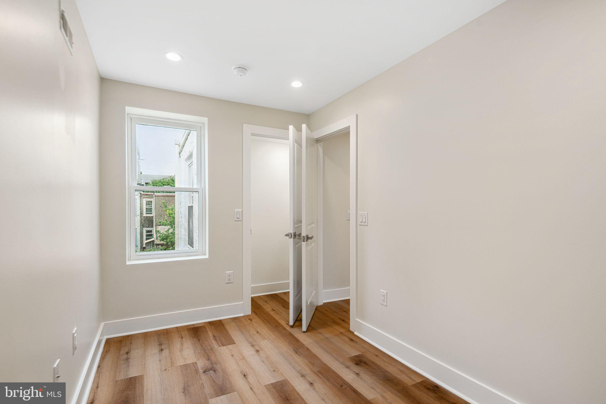 1812 East Letterly Street Philadelphia, PA 19125 - Photo 16 of 26 an empty room with wooden floor and windows
