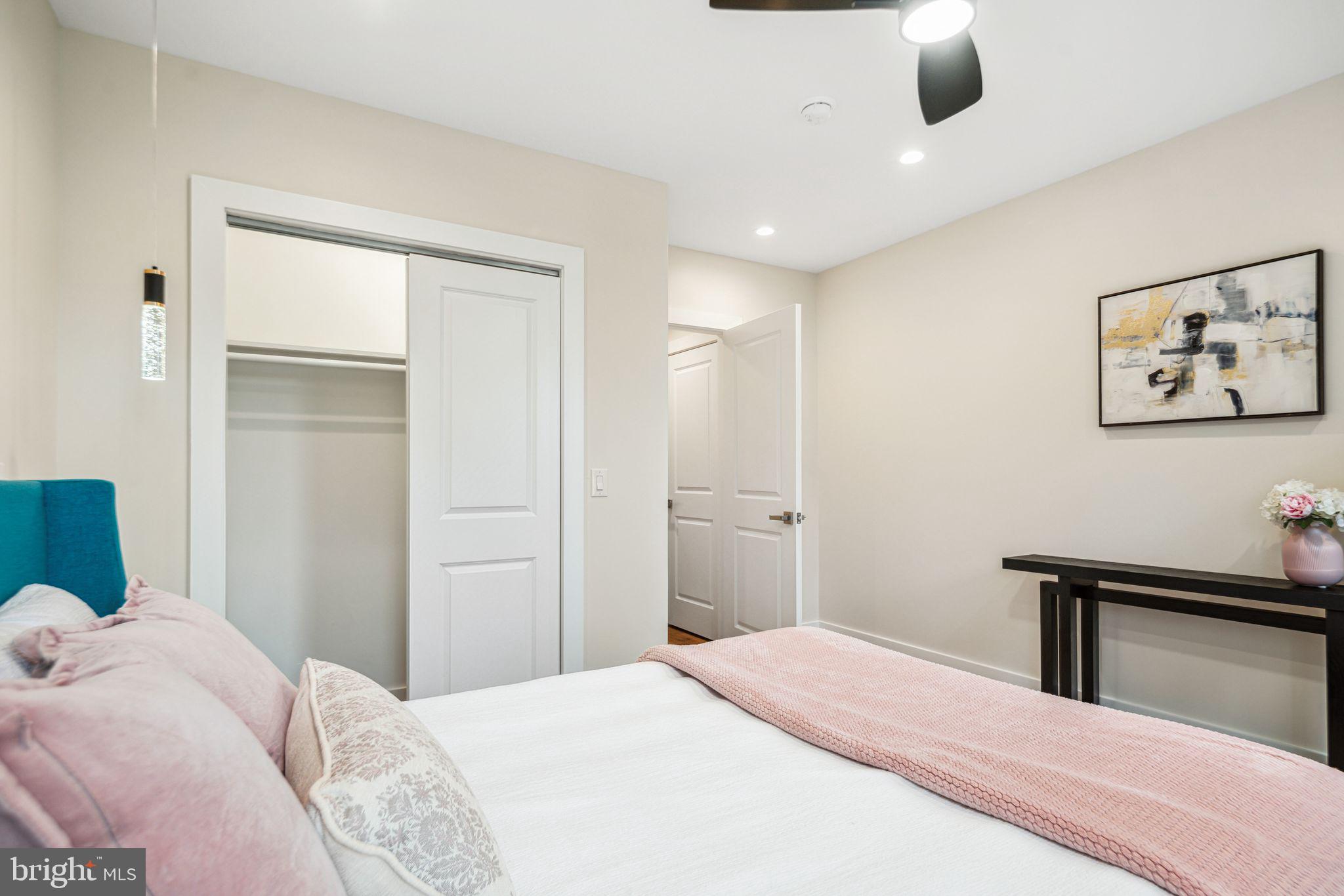 1812 East Letterly Street Philadelphia, PA 19125 - Photo 19 of 26 a bedroom with a bed and a chandelier
