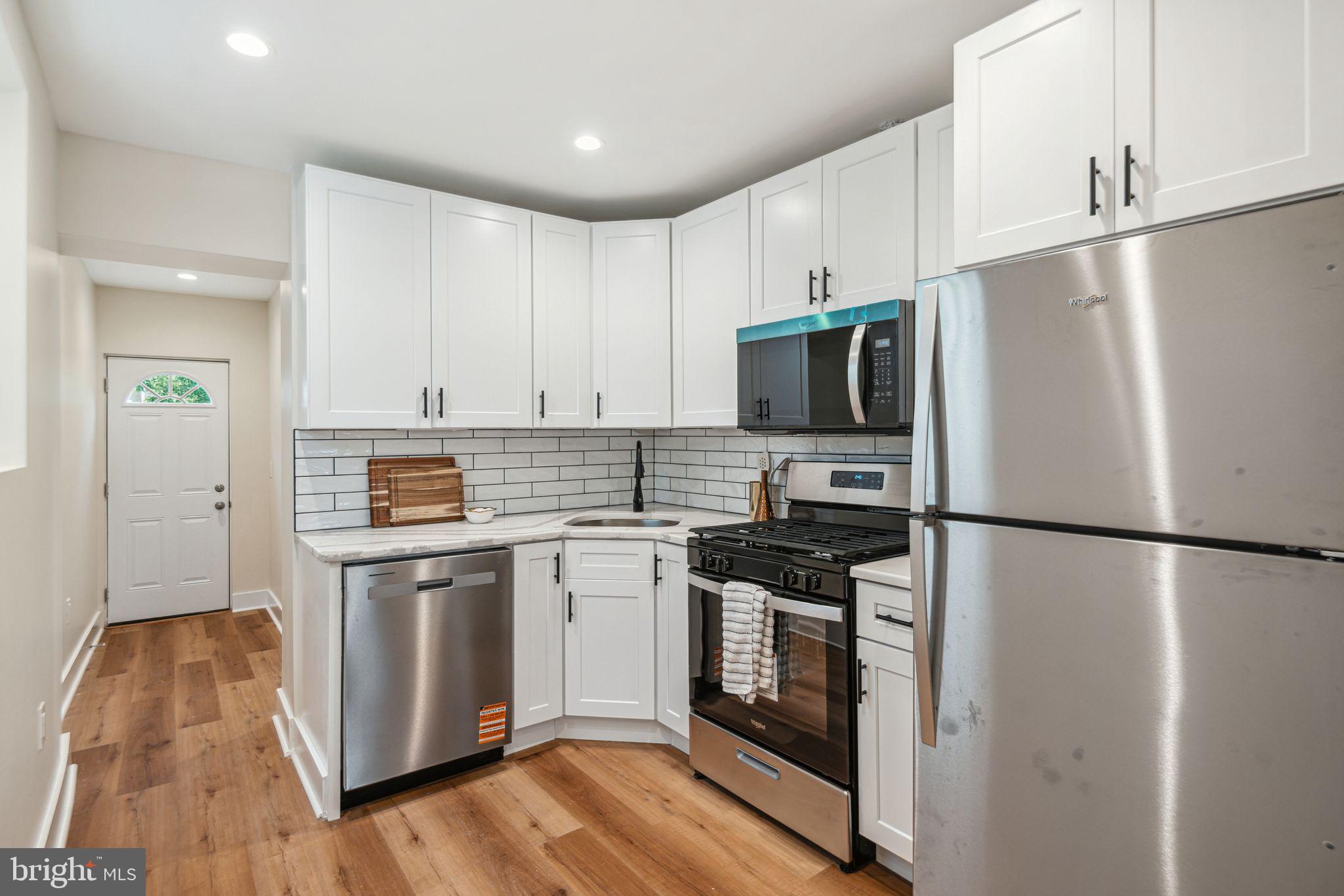 1812 East Letterly Street Philadelphia, PA 19125 - Photo 8 of 26 a kitchen with stainless steel appliances a refrigerator stove and microwave