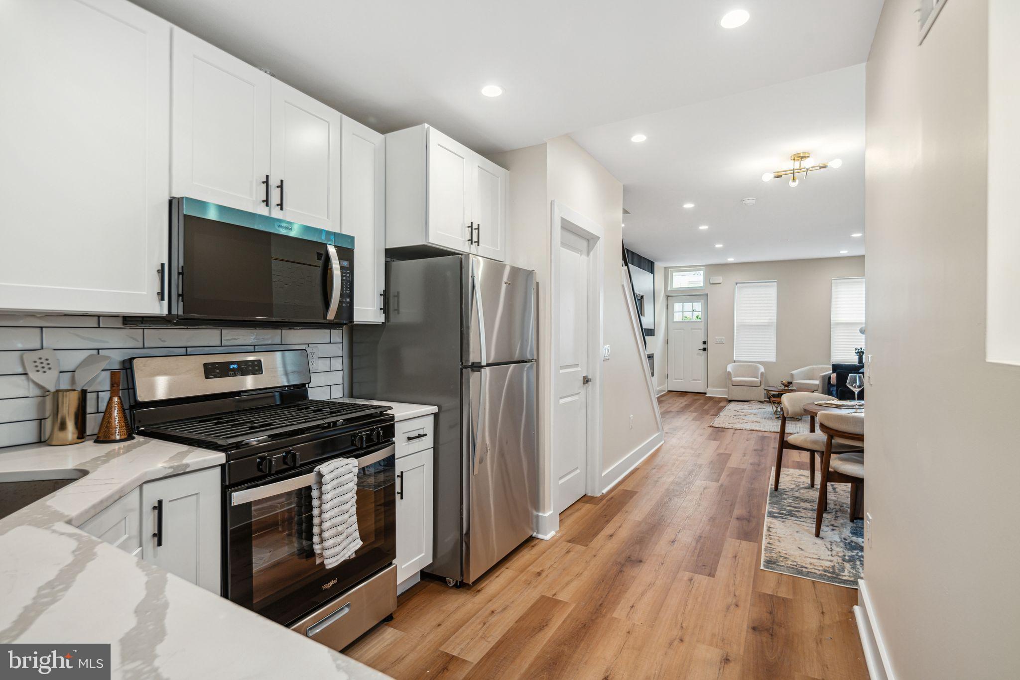 1812 East Letterly Street Philadelphia, PA 19125 - Photo 9 of 26 a kitchen with wooden cabinets and stainless steel appliances