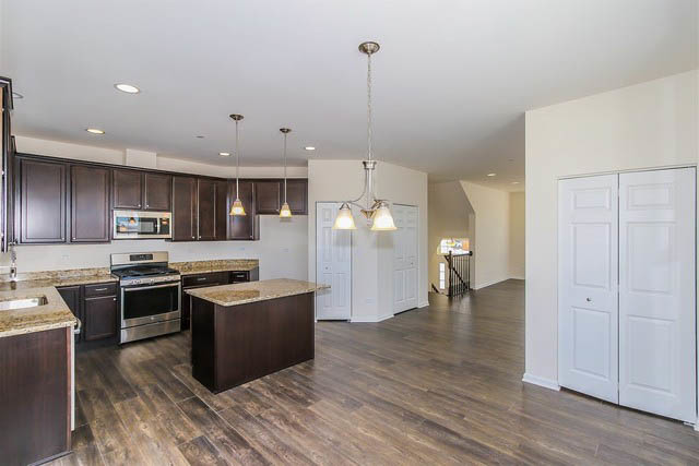 2949 Madison Drive Naperville, IL 60564 - Photo 11 of 29 a kitchen with stainless steel appliances granite countertop a refrigerator a stove top oven a sink dishwasher and a refrigerator with wooden floor