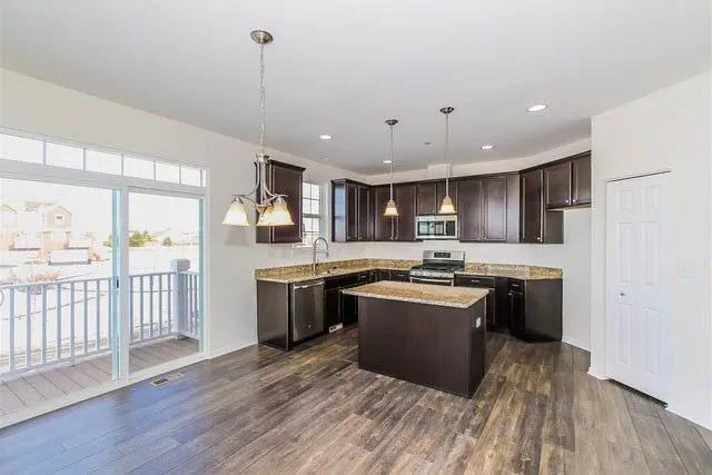 a kitchen with stainless steel appliances granite countertop a stove and a sink