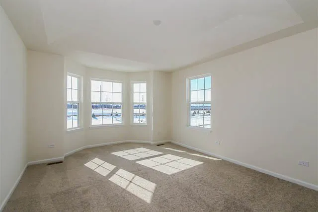a spacious bedroom with a bed and a window