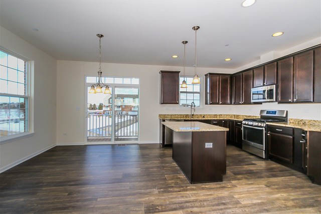 2949 Madison Drive Naperville, IL 60564 - Photo 9 of 29 a kitchen with stainless steel appliances granite countertop wooden cabinets a stove a sink and a wooden floors
