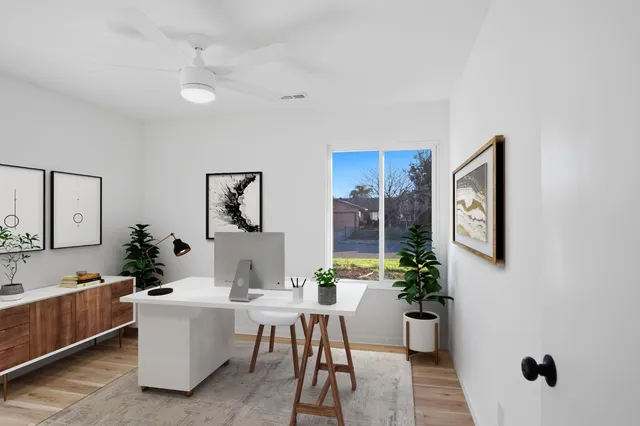 a living room with furniture a rug and white walls