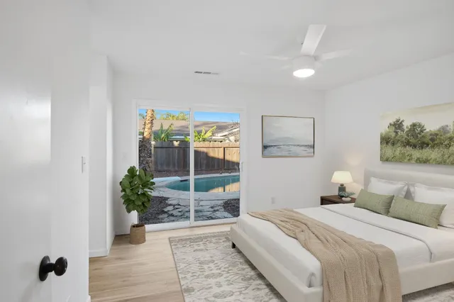 a bedroom with a bed and a potted plant