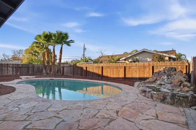a view of a swimming pool with a table and chairs