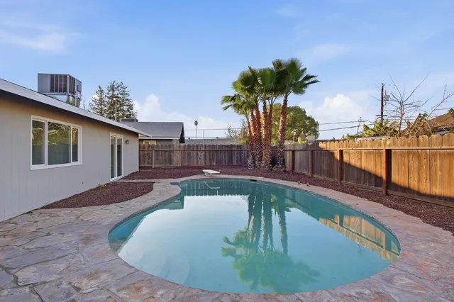 a view of a swimming pool with a lounge chairs