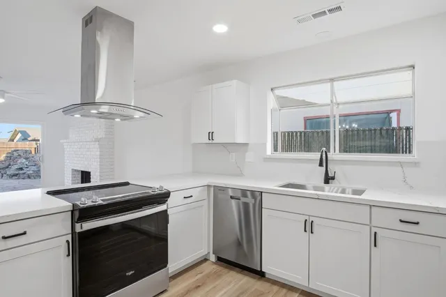 a kitchen with a sink stove and microwave
