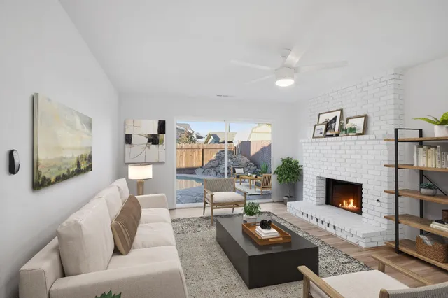 a living room with furniture and a fireplace