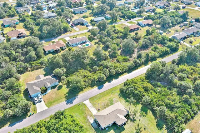 an aerial view of residential house with outdoor space and swimming pool
