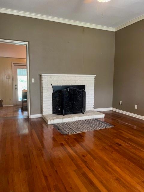248 South Jacobs Street Albany, TX 76430 - Photo 7 of 17 Den featuring hardwood floors, crown molding, and a brick fireplace