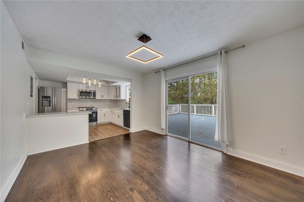 635 Anderson Walk Marietta, GA 30062 - Photo 11 of 39 a view of kitchen with granite countertop cabinets and wooden floor