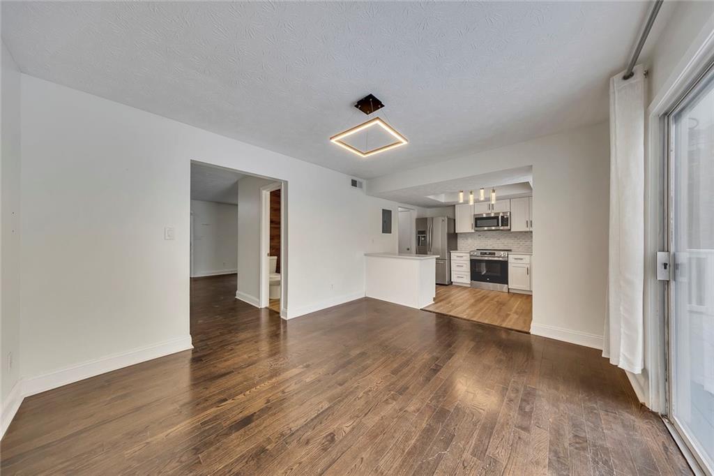 635 Anderson Walk Marietta, GA 30062 - Photo 12 of 39 wooden floor in an empty room with a window