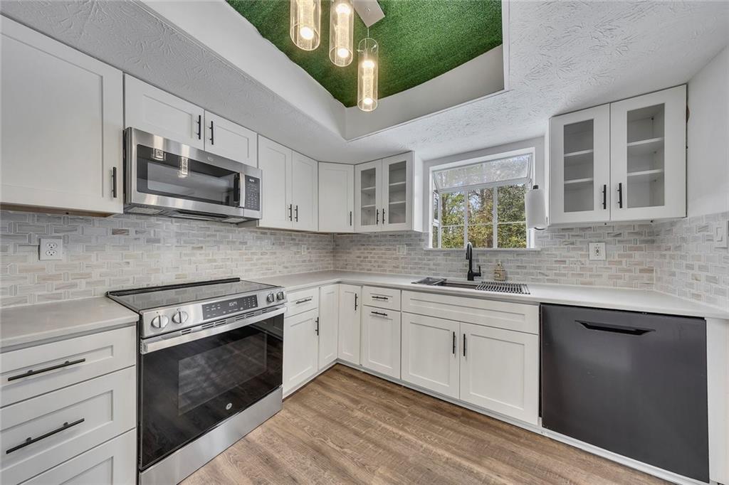 635 Anderson Walk Marietta, GA 30062 - Photo 14 of 39 a kitchen with stainless steel appliances granite countertop a stove and cabinets