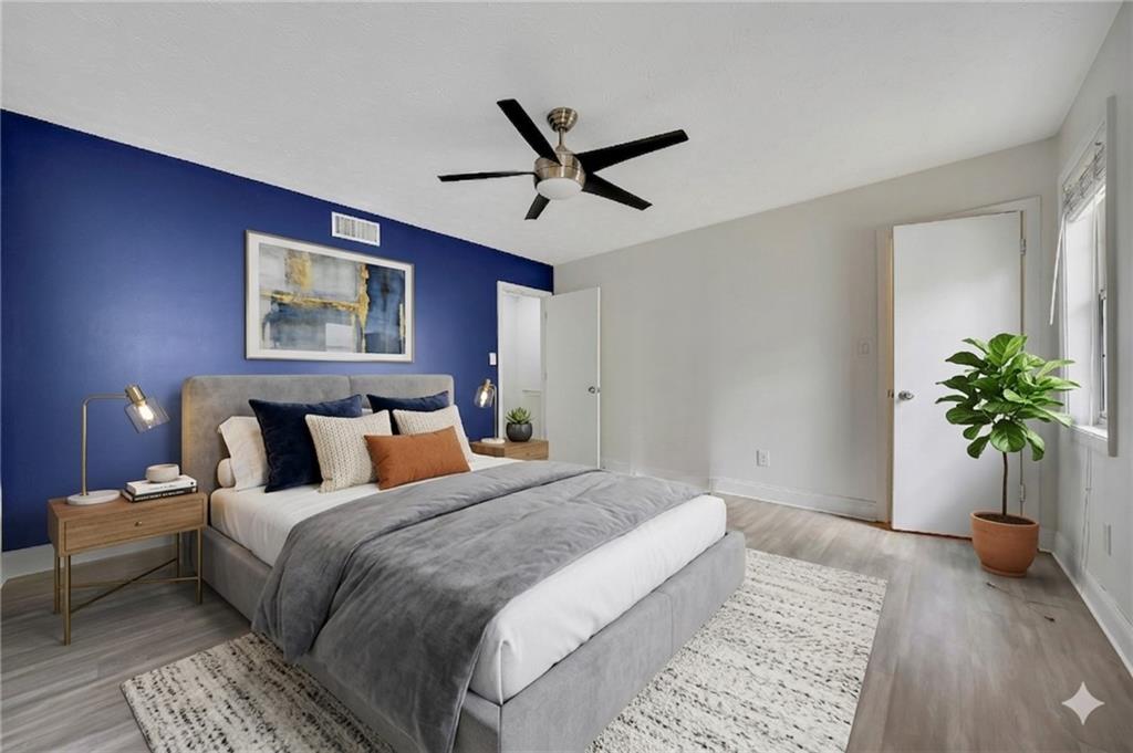 635 Anderson Walk Marietta, GA 30062 - Photo 20 of 39 a bedroom with a large bed and a potted plant