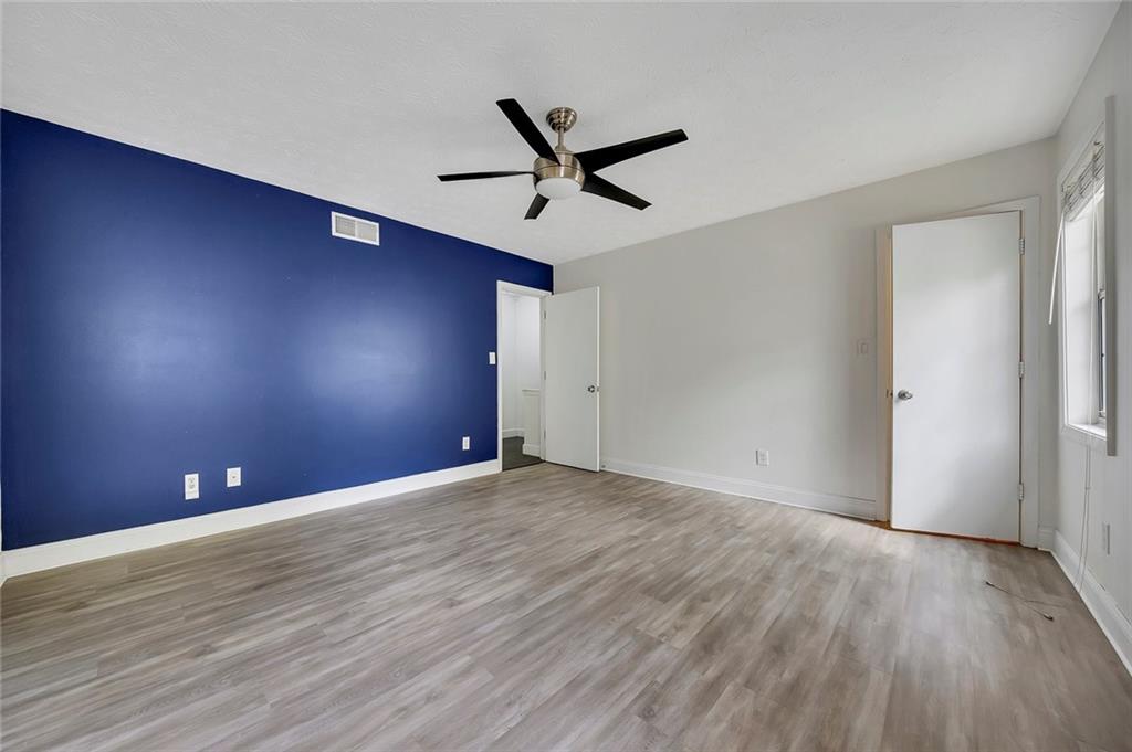 635 Anderson Walk Marietta, GA 30062 - Photo 21 of 39 an empty room with a ceiling fan and window