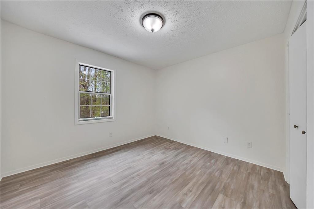 635 Anderson Walk Marietta, GA 30062 - Photo 23 of 39 an empty room with wooden floor and windows