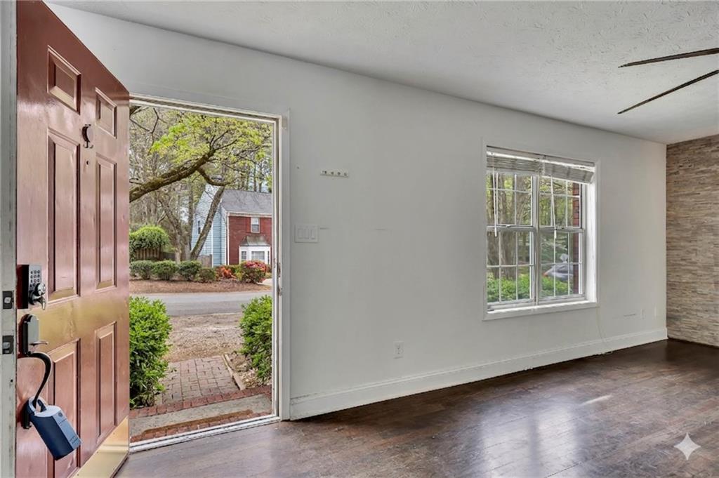 635 Anderson Walk Marietta, GA 30062 - Photo 5 of 39 an empty room with wooden floor and windows