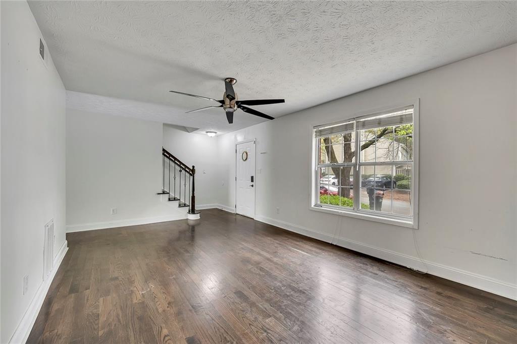 635 Anderson Walk Marietta, GA 30062 - Photo 8 of 39 a view of an empty room with wooden floor and a window