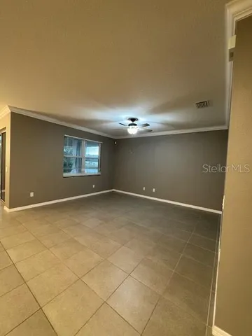 a view of an empty room with windows