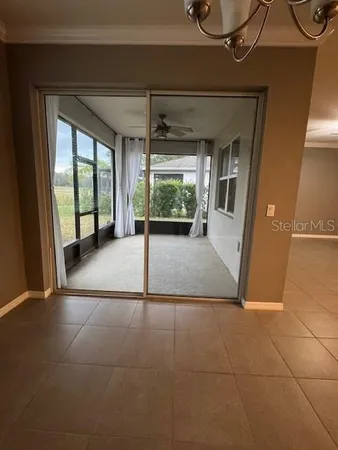 a view of a room with wooden floor and windows
