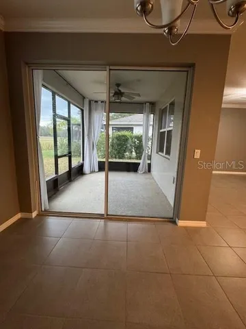 a view of a room with wooden floor and windows