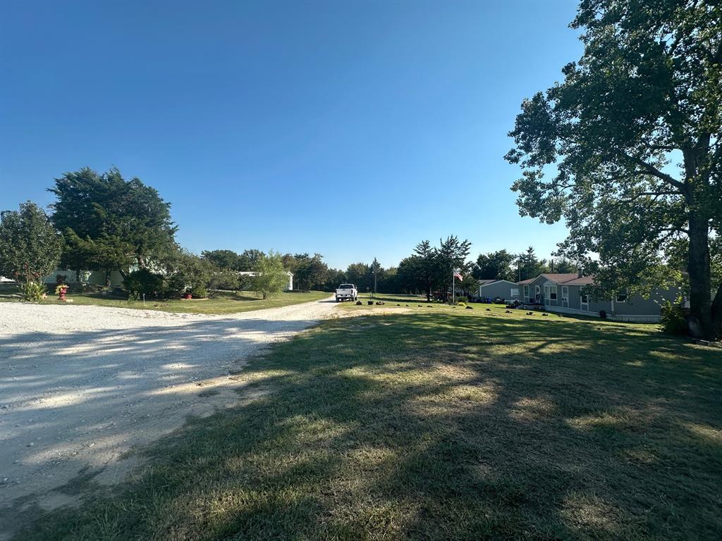 248 1st Street Oak Ridge, TX 76240 - Photo 3 of 7 a view of an outdoor space and yard