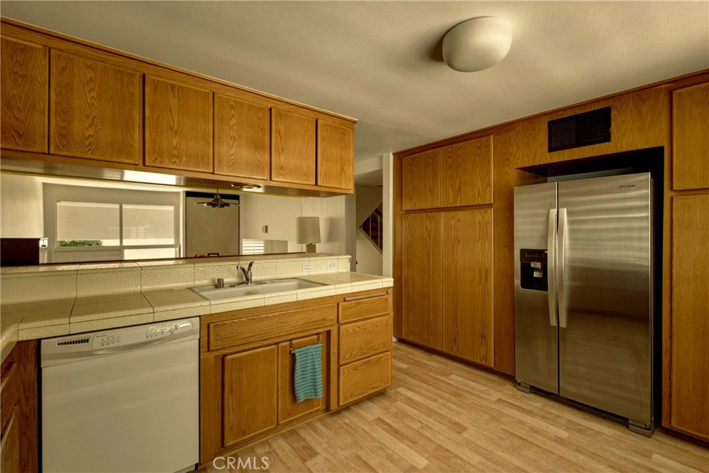4331 West Sarah Street, Unit 10 Burbank, CA 91505 - Photo 11 of 26 a kitchen with stainless steel appliances granite countertop a sink and cabinets